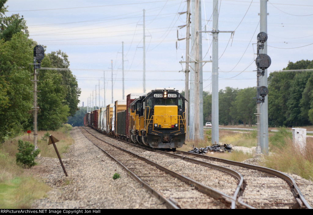 Tied down in the siding, GDLK302 waits for a crew van after coming up from Elkhart